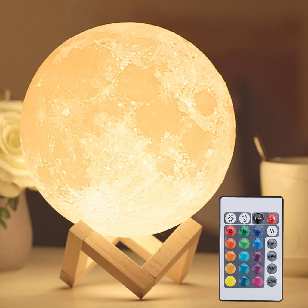 Moon lamp glowing warm white on a wooden stand, with its colour remote control